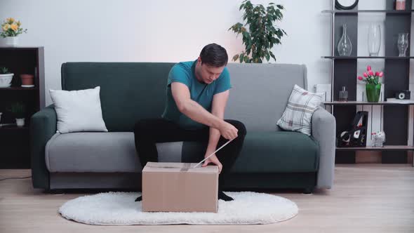 The man opens the package and is very happy with what is in it