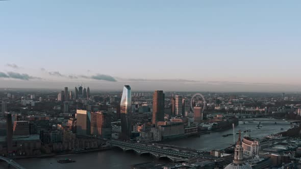 Establishing drone shot of central London revealing St Pauls cathedral sunrise alt