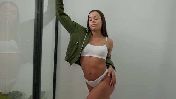 Gorgeous Woman in Underwear Looking at Camera Standing in Shower Cabin Turning in Slow Motion alt