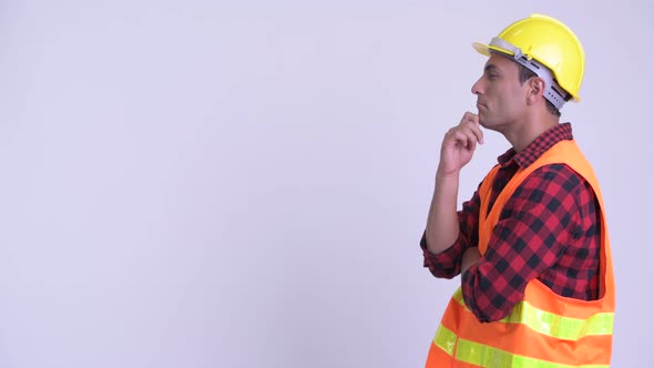 Profile View of Young Happy Hispanic Man Construction Worker Thinking