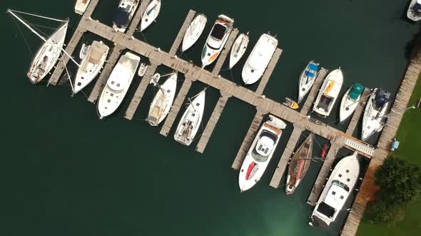 Aerial shot over a marina filled with sailboats. alt