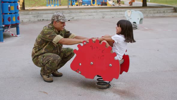 Military Daddy Playing with Active Kid Outdoors alt