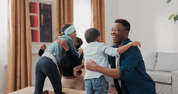 Parents are Looking for Children Who are Playing Hide Seek Among Boxes Left Over From Move Married alt