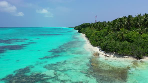 Beautiful overhead tourism shot of a paradise sunny white sand beach and blue sea background in colo alt