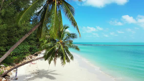 Beautiful fly over abstract shot of a white paradise beach and blue sea background in high resolutio alt