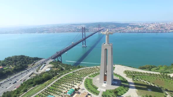 Aerial view of Sanctuary of Christ the King overlooking Lisbon and 25 de Abril Bridge connecting Lis alt