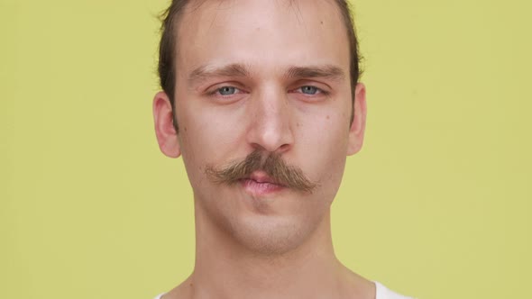 Expressive Man Having Fun Blinking and Joyfully Playing with Eyebrows Concept of Emotions alt