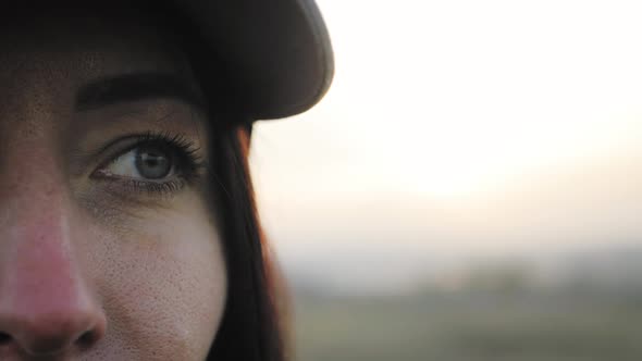 Portrait of Young Woman Looking Up at Sunset Sky alt