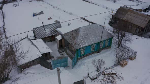 Old Wooden Houses in the Russian Village Covered with Snow