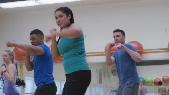 Group of people doing exercise class at gym