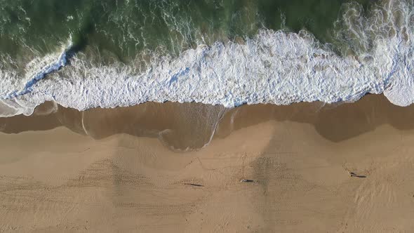 Drone View of Coastline with Waves Rolling Into Coast