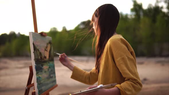 Young Artist Draws a Palette Knife Still Life the Girl is Near the Sea or Rivers alt