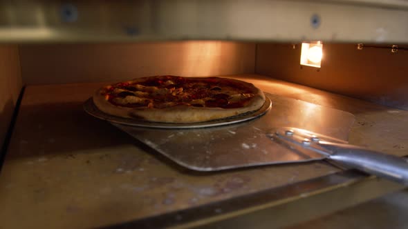 Italian Chef Is Placing Pizza Slow Motion Shot. Series of Shots About Pizza. Appetizing Sauce alt