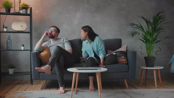 Young Couple Sitting on the Sofa alt