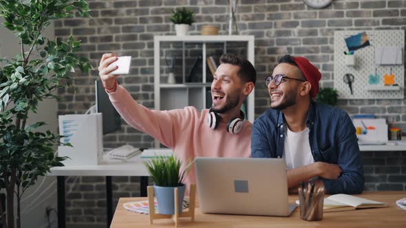 Bearded Young Men Taking Selfie with Smartphone Camera at Work in Modern Office alt