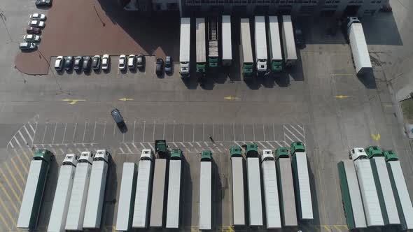 Buildings of Logistics Center Warehouses Near the Highway View From Height a Large Number of Trucks alt