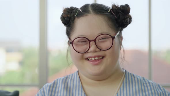 Portrait, girl with Down syndrome laughing