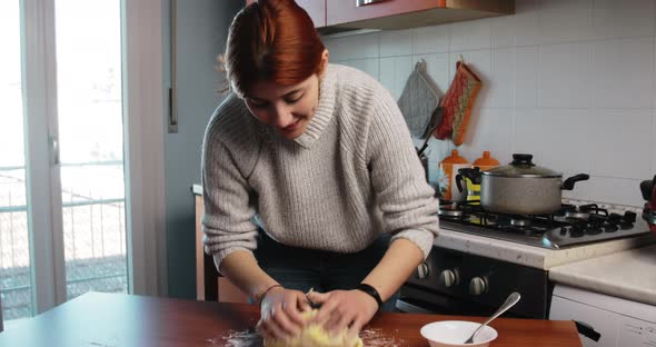 Young Italian Girl is Kneading the Potato Dough for the Homemade Gnocchi alt
