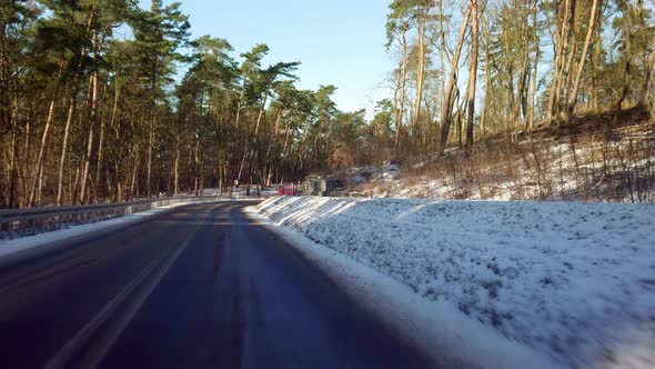Driving a car through the winter forest
