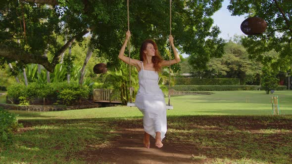 A Childhood Dream of Flying High on a Swing in a Green Forest alt
