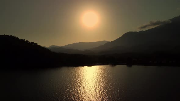 Sunset Over Mediterranean Sea and Mountain Ridge in Turkey Filmed By Drone at Summer Evening alt