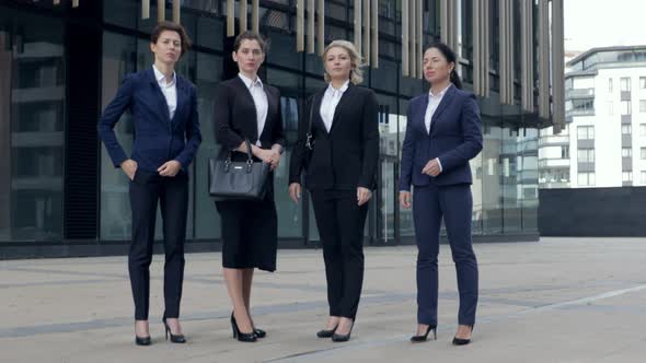 Four Serious Successful Business Women Are Standing with Crossed Arms. Looking at Camera, Ready 