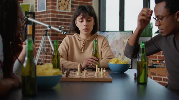 Portrait of Happy Woman Enjoying Bottle of Beer at Fun Gathering alt