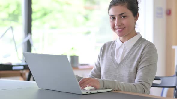Cheerful Indian Woman with Laptop Smiling at Camera alt