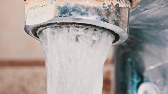 Macro Shot of Faucet with Running Water in Slow Motion alt