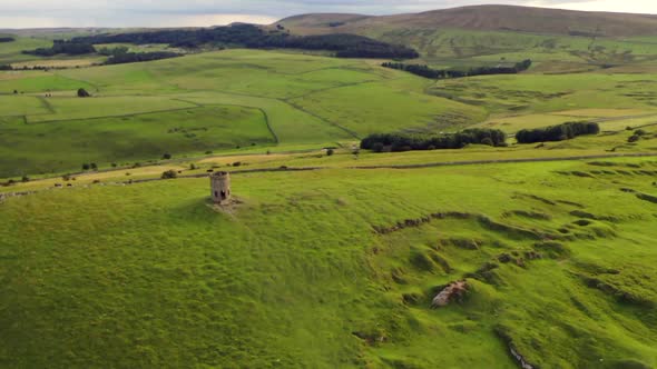 Solomon's Temple in Buxton, Derbyshire, UK shot from a drone at sunset. The camera rotates around th alt