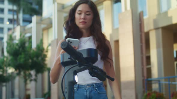 Asian Lady Rent Scooter Pay Using Smartphone Close Up alt