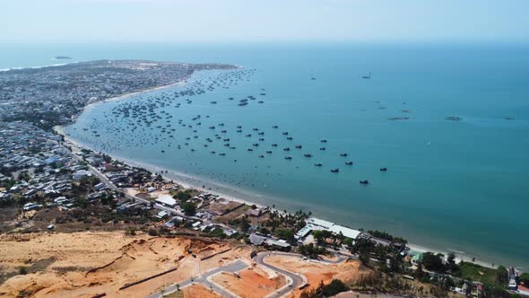 Aerial panorama, beach coast of Mui Ne fishing village in Vietnam on summer day alt