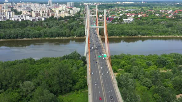 Car driving on highway bridge and road intersection in modern city aerial view alt
