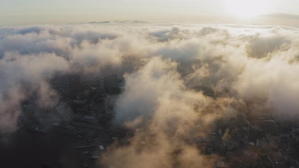 View From a Drone of City Center Above Which Clouds are Rapidly Floating alt
