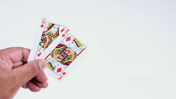 Hand Holds King And Queen Diamonds alt