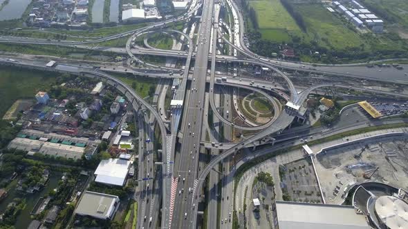 Aerial View of Highway Road Interchange with Busy Urban Traffic Speeding on Road alt