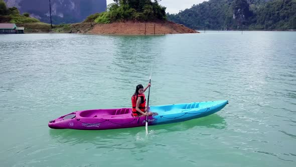 Cute Asian Girl Chilling Kayaking in Cheow Lan Lake Thailand alt