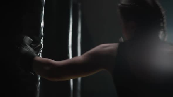 Aggressive Woman Fighter Trains His Punches Beats a Punching Bag Training Day in the Boxing Gym alt