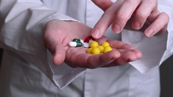 A Female Doctor Hold in Hands Tablets and Vitamins. Treatment of Sick People alt