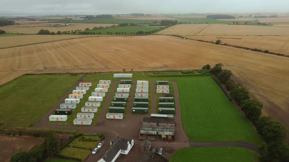 Drone Footage of Temporary Farm Workers' Housing Surrounded By Green Lawns