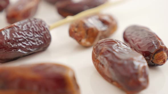 Delicious  palm dates  exotic fruit on white background slow panning  4K 2160p UltraHD footage - Pho alt