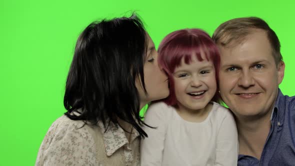 Happy Family of Three Father, Mother and Daughter. Hug, Play, Laughing, Smiling alt