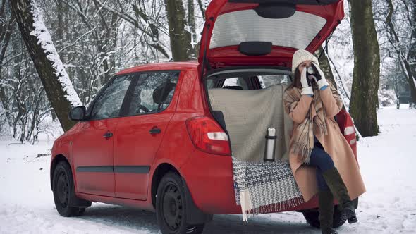 Tea party in car trunk - loving couple sits in car trunk in Valentine's day alt