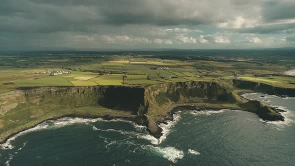 Cliff Ocean Ireland Shore Aerial View: Green Grassy Valley with Little Farms in Irish Countryside alt