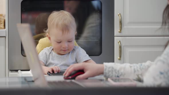 Woman with Baby Working at Home alt
