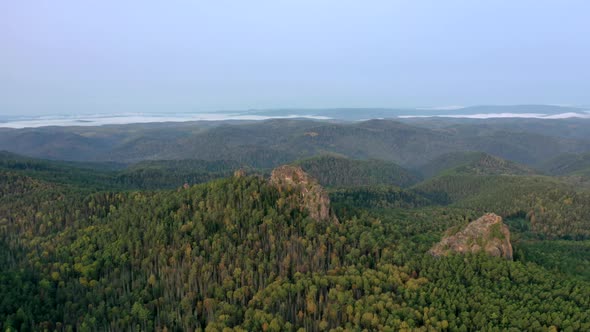 Aerial Hyperlapse of Rock Peaks in the Forest at Dawn. Stolby National Park, Krasnoyarsk, Russia.