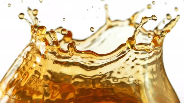 Super Slow Motion Shot of Brown Liquid Splash Isolated on White Background at 1000Fps alt