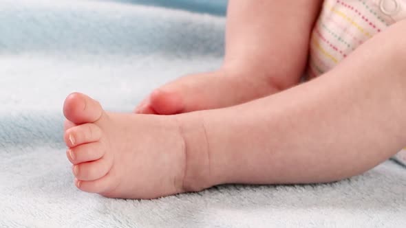 Close-up of moving legs and feet of a small baby