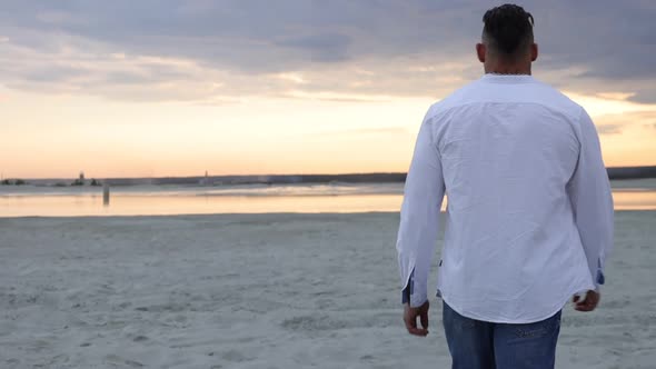 Brutal Man Walking on Beach