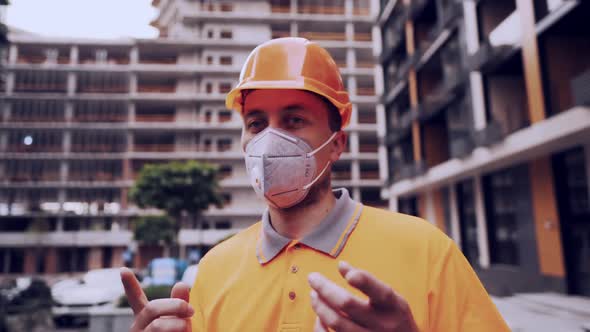 Foreman in Protective Helmet and Respirator Checking the Construction Process and Talking with a alt